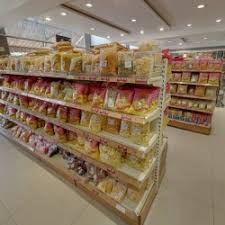 Shelves of packed namkeen varieties — Dharti Namkeen & Sweets