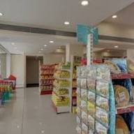Packaged snacks display near the entrance — Dharti Namkeen & Sweets
